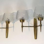 Pair of bronze wall sconces with worked glass reflectors. Stilnovo