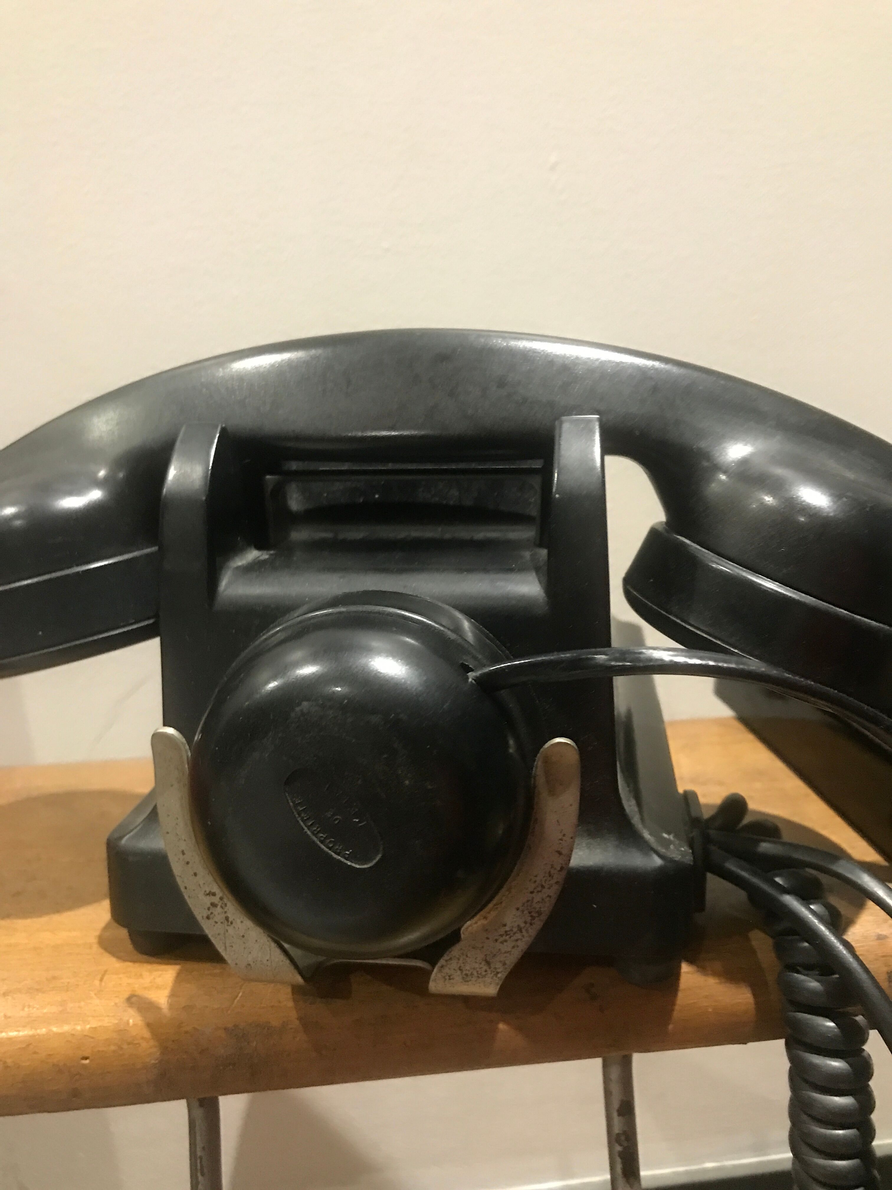 Black bakelite dial telephone with support
