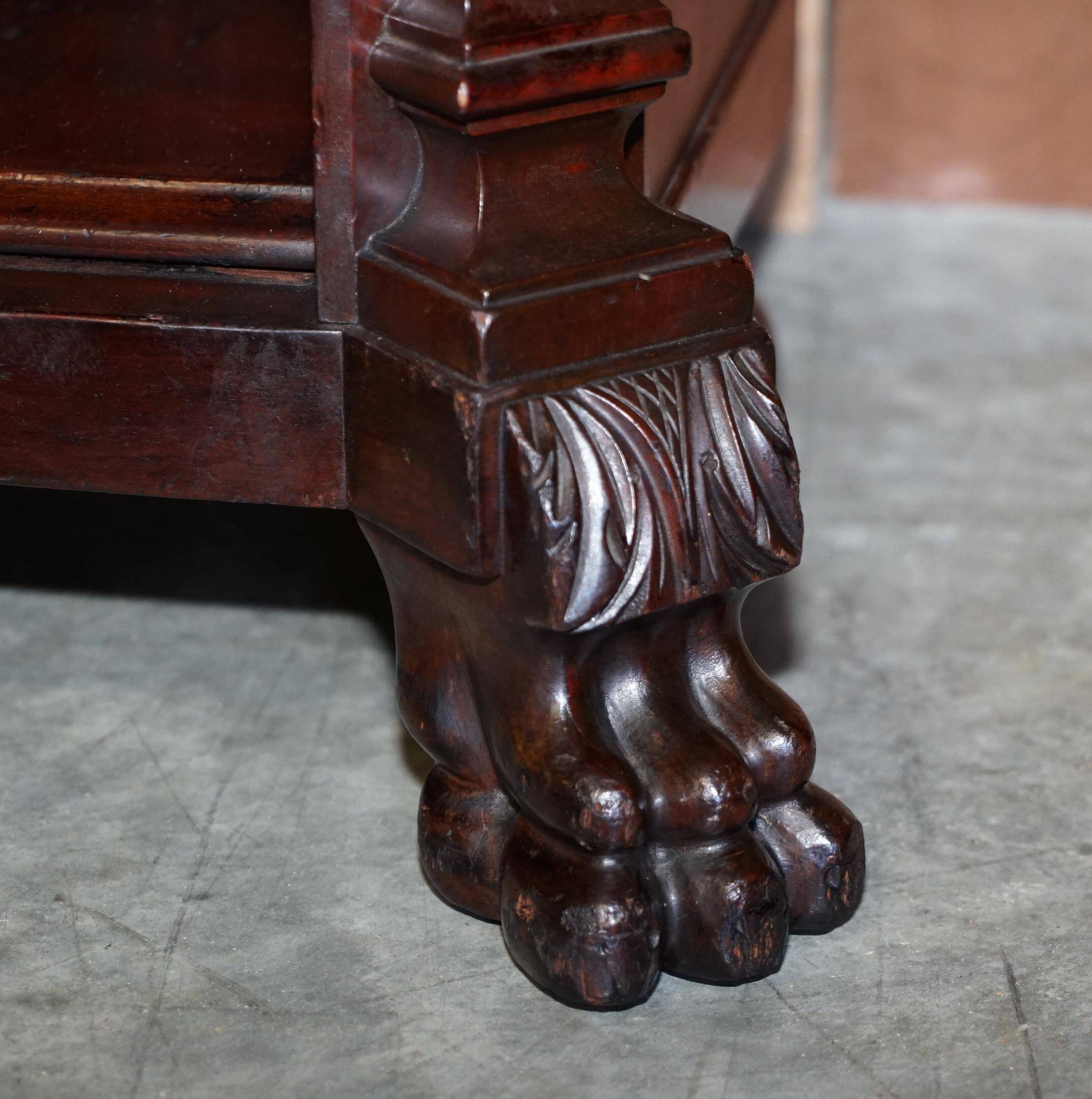 Hand-carved library circa 1900 in hardwood with Hermes statues.