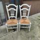 Pair of straw-seated chairs with white-stained wood.