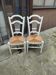 Pair of straw-seated chairs with white-stained wood.