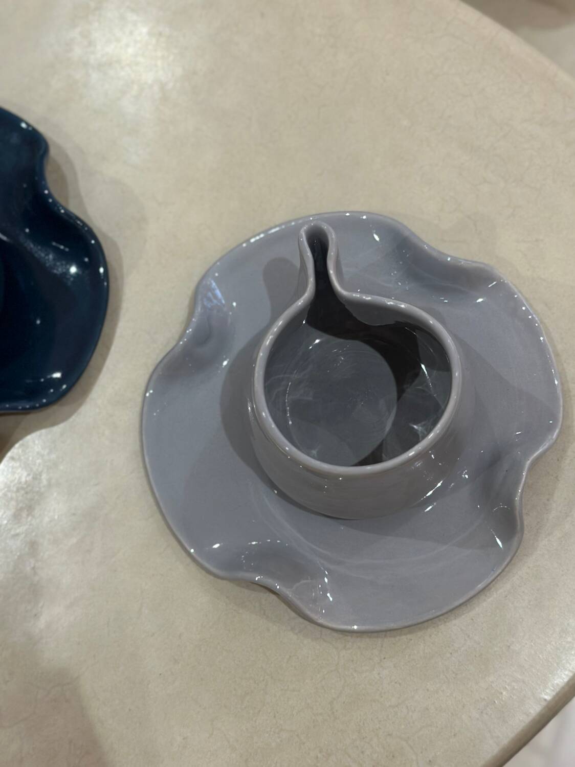 Set of ceramic artisan mugs with blue-grey pop water lily design.