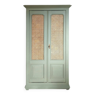 Caned cabinet with oranges