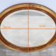 Miroir ovale en bois doré – début XXe