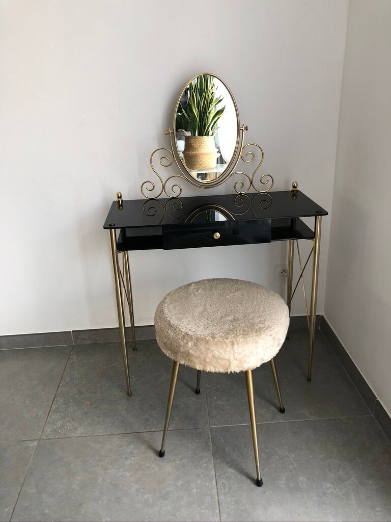 Brass hairdresser, glass and black plastic with its fluffy stool.