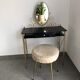 Brass hairdresser, glass and black plastic with its fluffy stool.