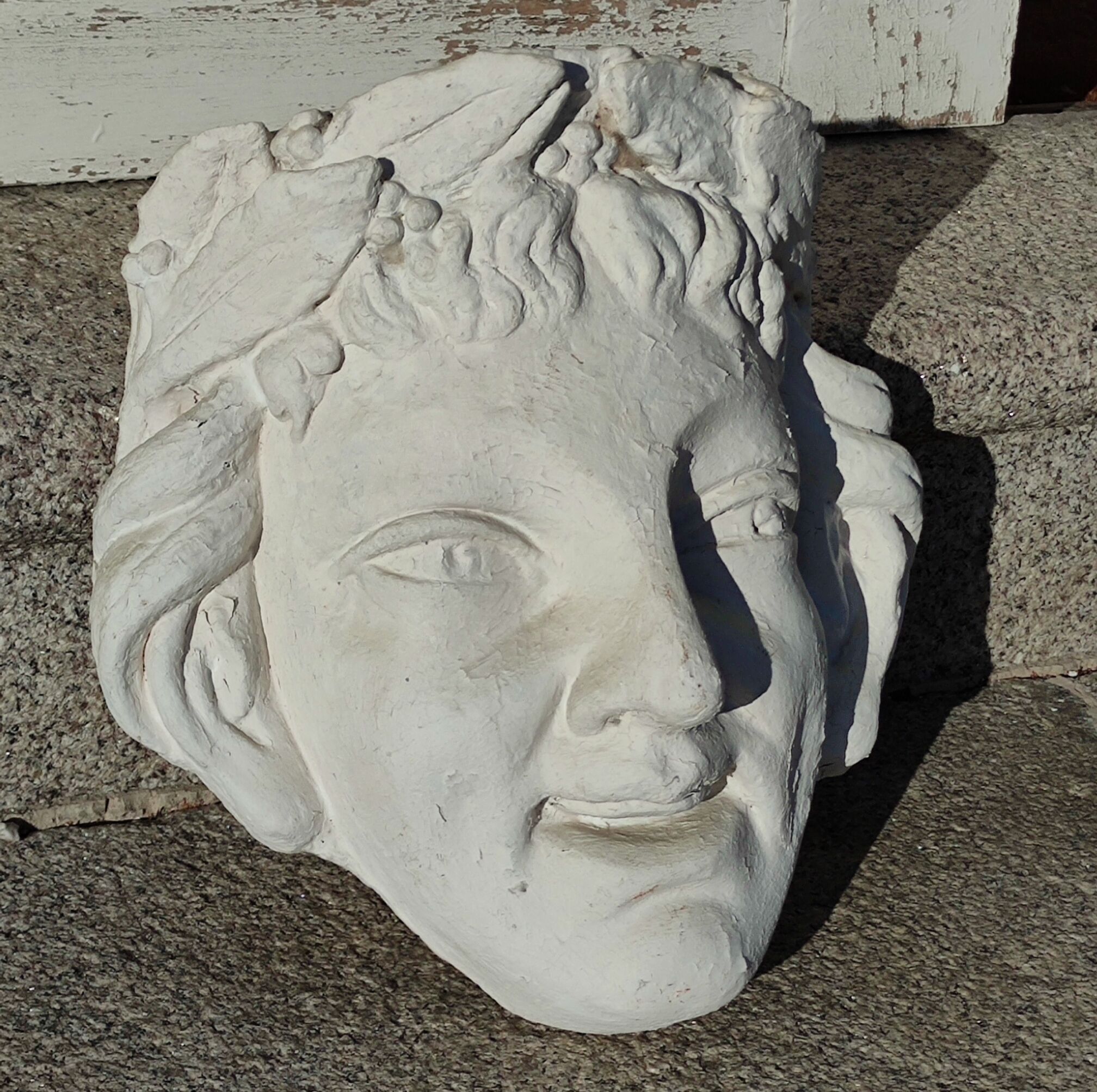 Old face in plaster antique decoration