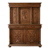 Large antique wooden sideboard carved in rustic style.