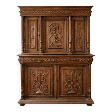 Large antique wooden sideboard carved in rustic style.
