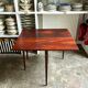 Folding table, dark wood console.