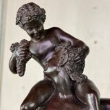 Dionysus on the shoulders of a satyr, bronze after the antique on a yellow Siena base.