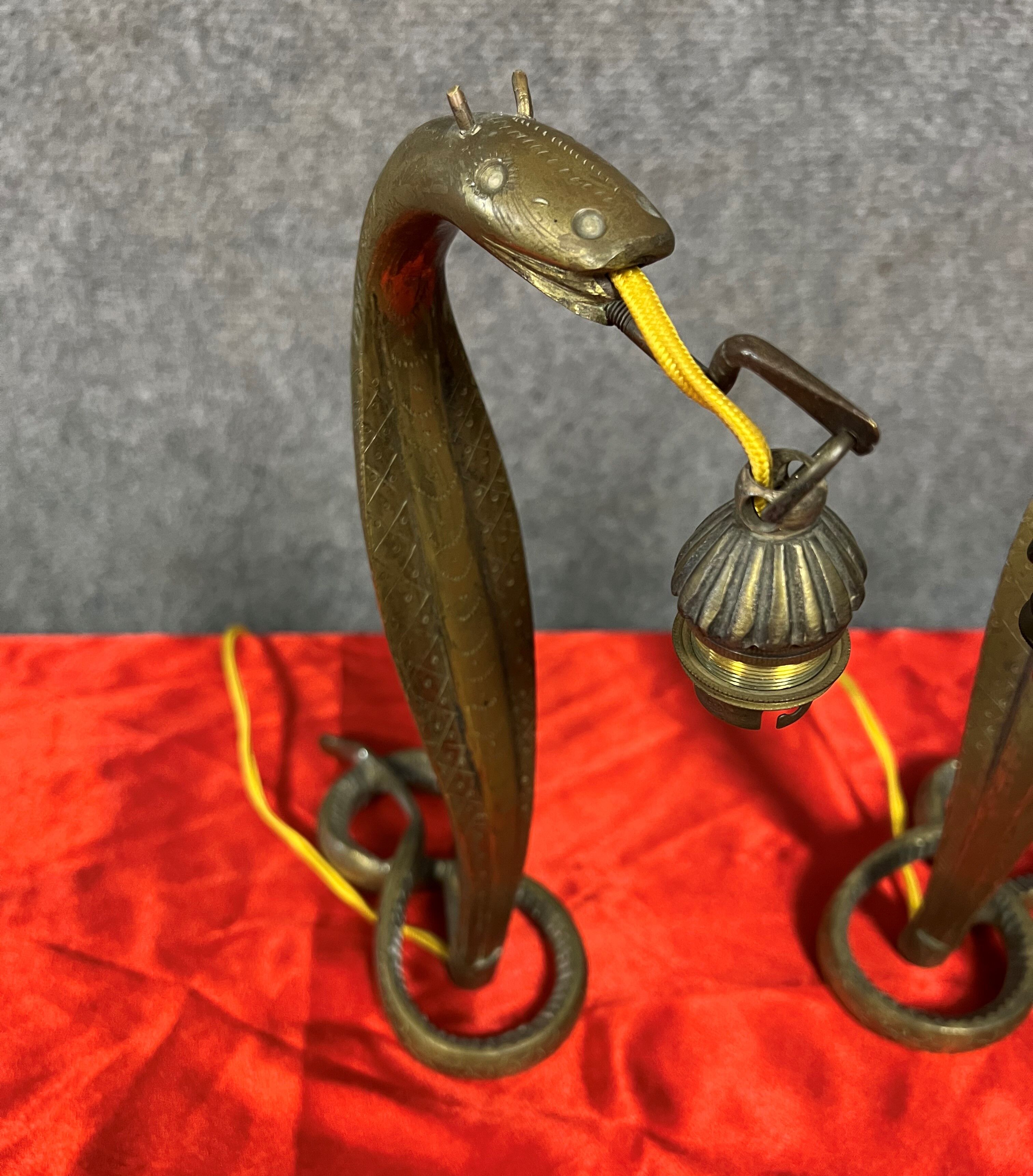 Pair of cobra lamps in gilded bronze