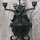 Pair of black wrought iron wall sconces - neo-Gothic style - from the 1950s