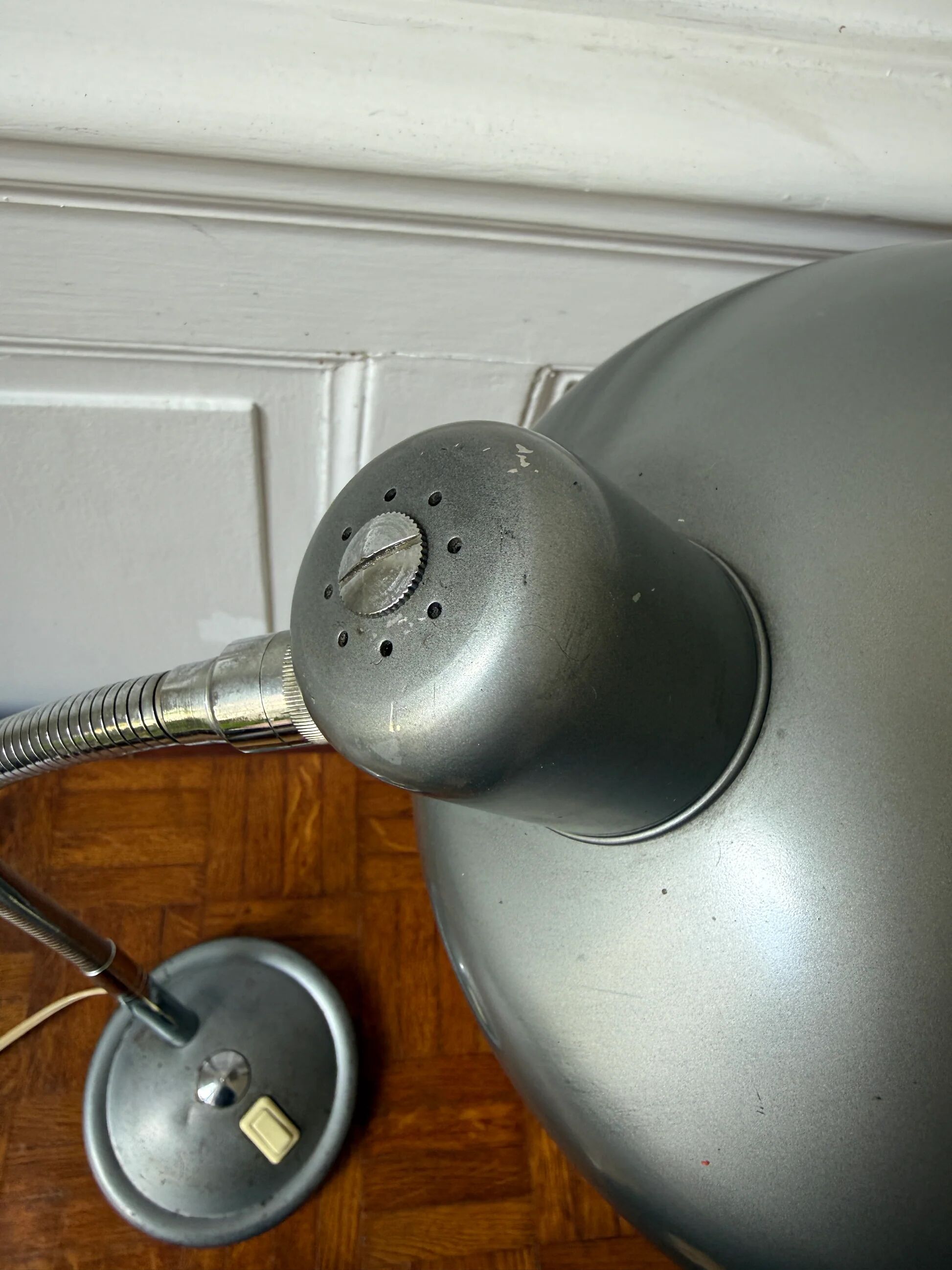 Industrial metal workshop lamp with a gooseneck.
