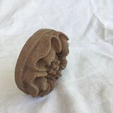 Pink sandstone paperweight in the shape of a rosette