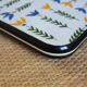 Vintage laminated wooden trivet with yellow, green, and blue flowers