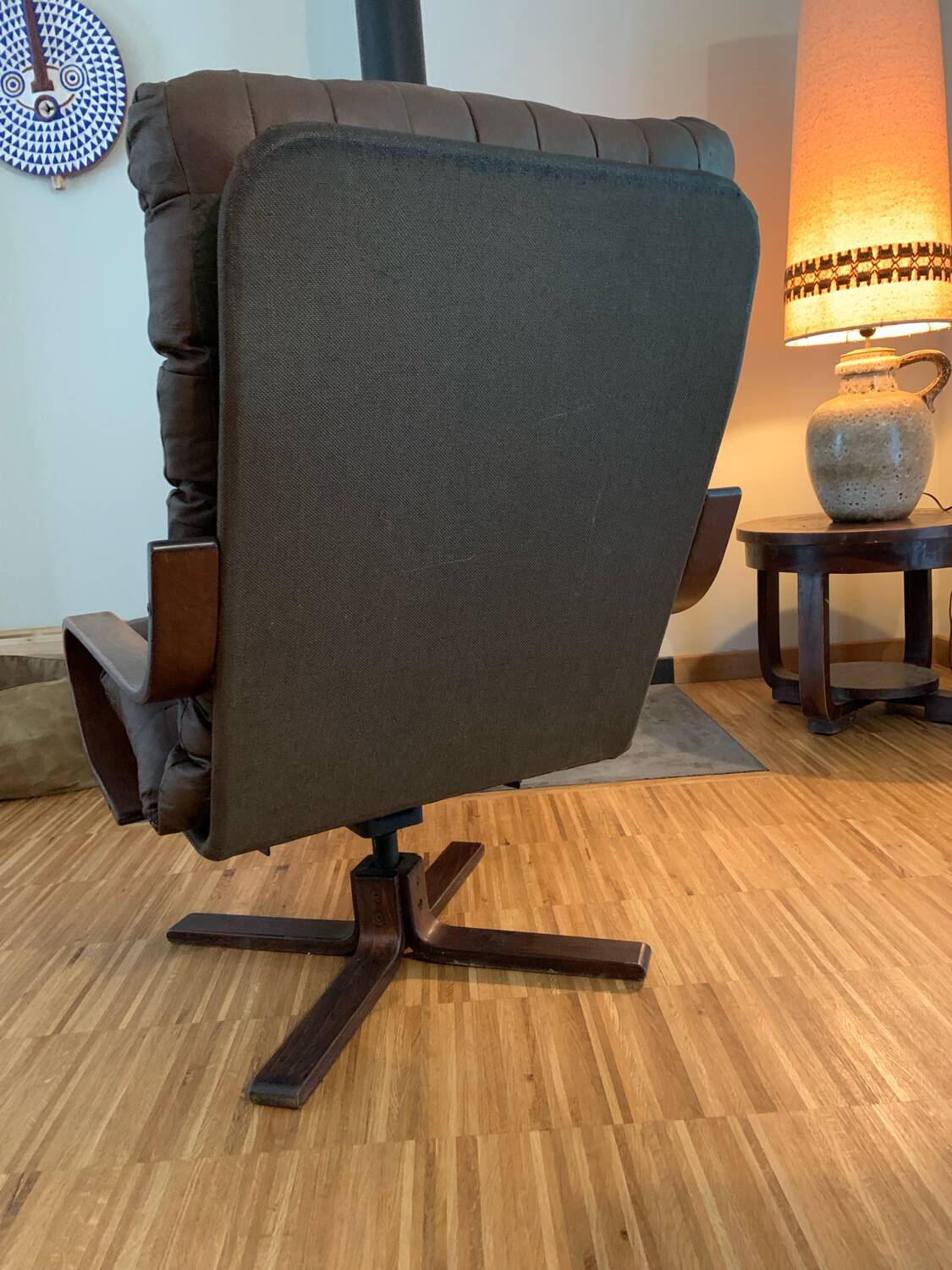 Vintage leather armchair with wooden armrests