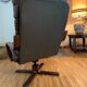 Vintage leather armchair with wooden armrests