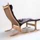 Fauteuil Siesta en cuir marron et son ottoman