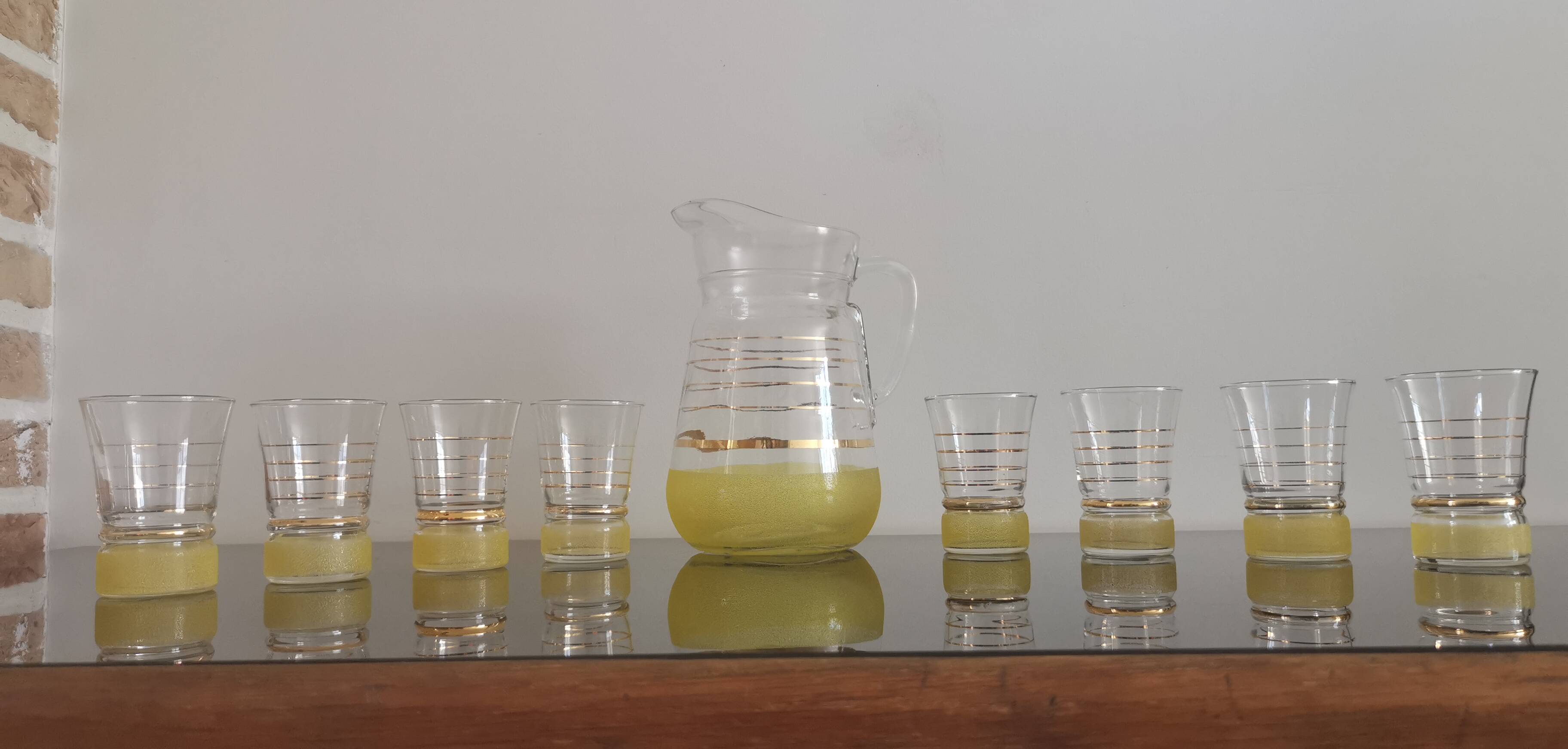Old pitcher with its 8 yellow granite glasses with gold edging vintage 50's