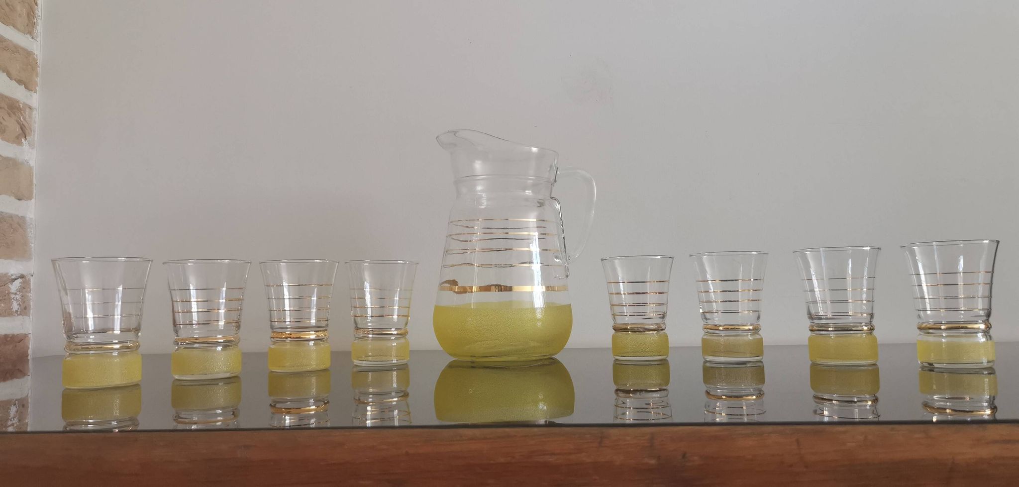 Old pitcher with its 8 yellow granite glasses with gold edging vintage 50's