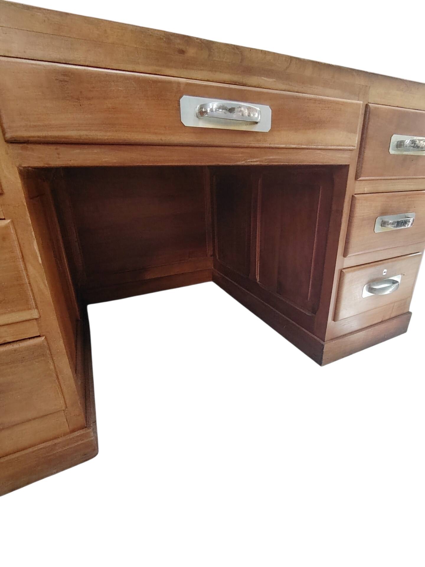 Large modernist minister's desk in solid lemon wood with 7 drawers.