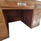 Large modernist minister's desk in solid lemon wood with 7 drawers.
