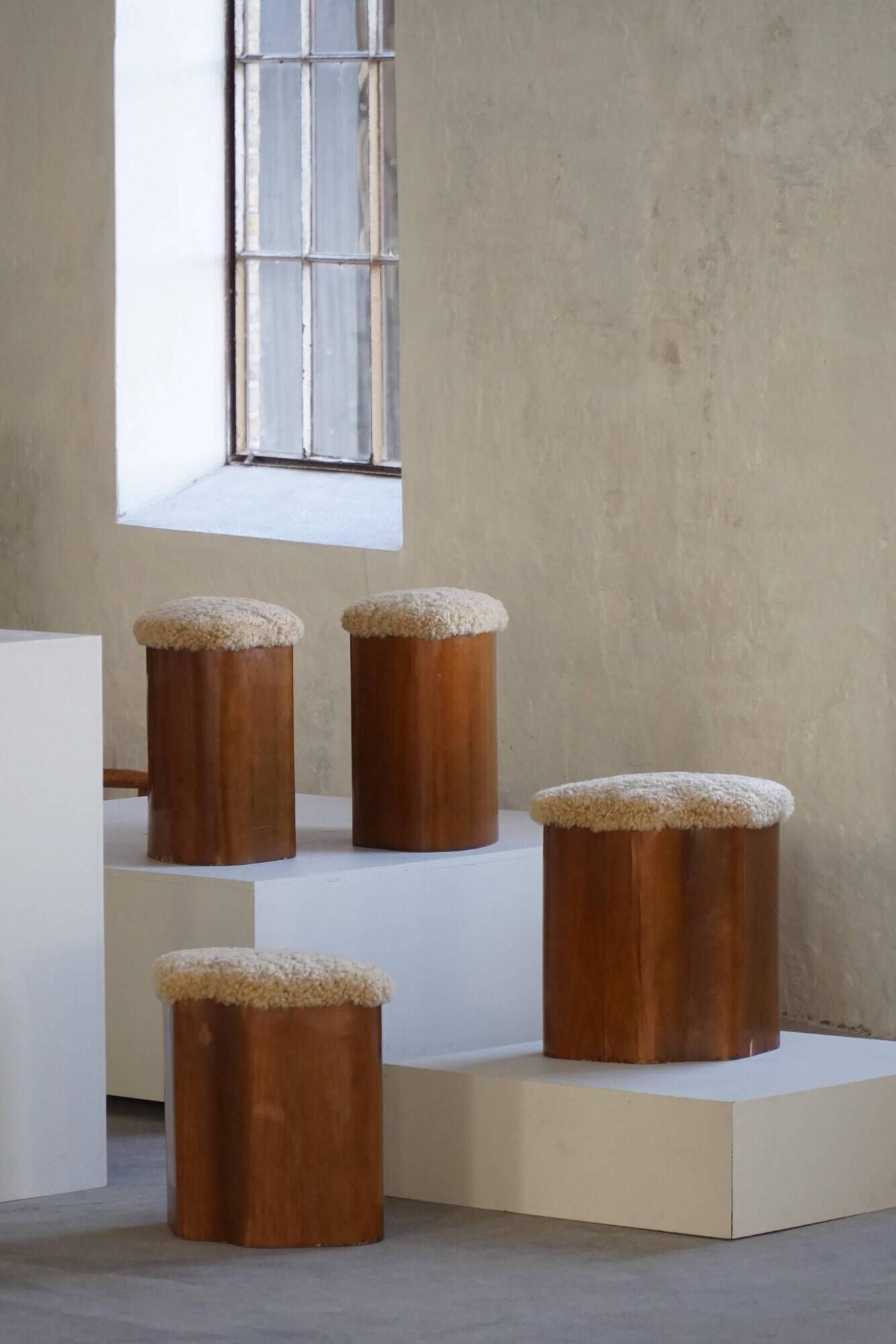 Set of 4 sculptural French Art Deco stools in wood and lamb's wool, 1940s.