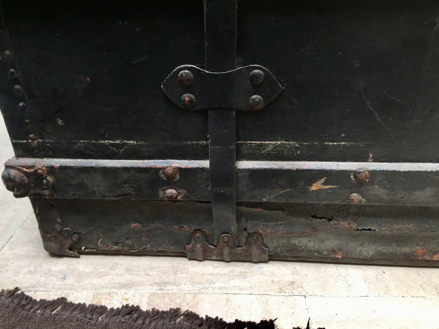 Black ancient travel trunk, 19th