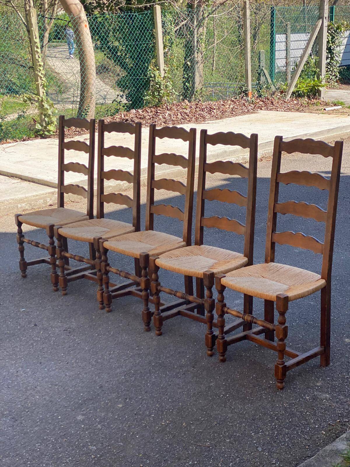 4 or 5 solid wood chairs with light oak straw and high backs