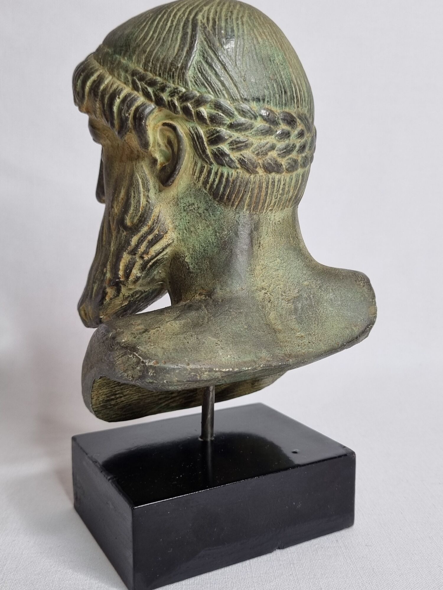 Bust of Poseidon in patinated plaster on wooden base