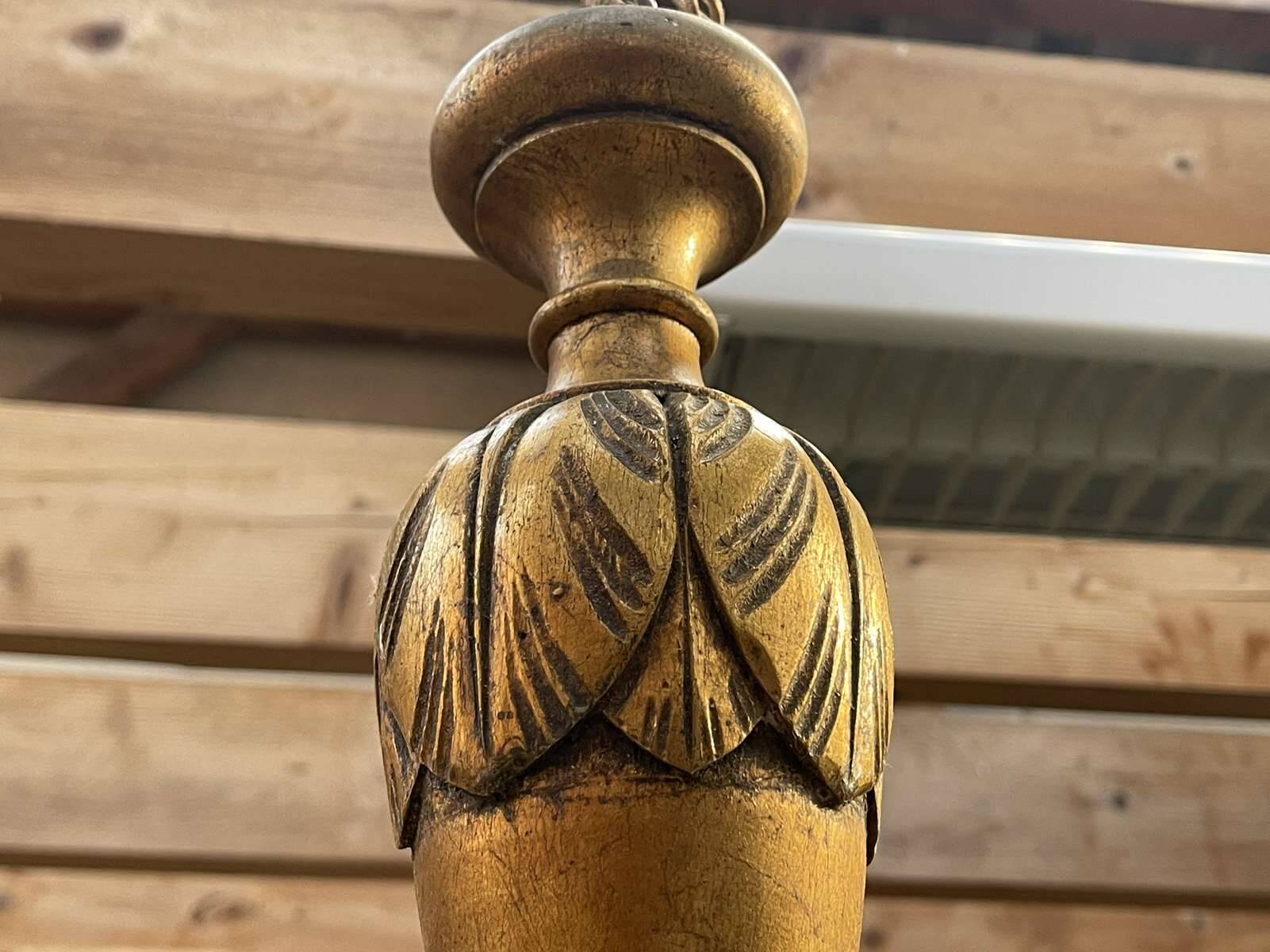 Golden wooden chandelier with crystal pendants from the 19th century.