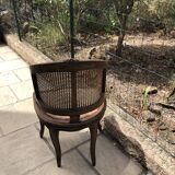 Old wooden armchair and cannage
