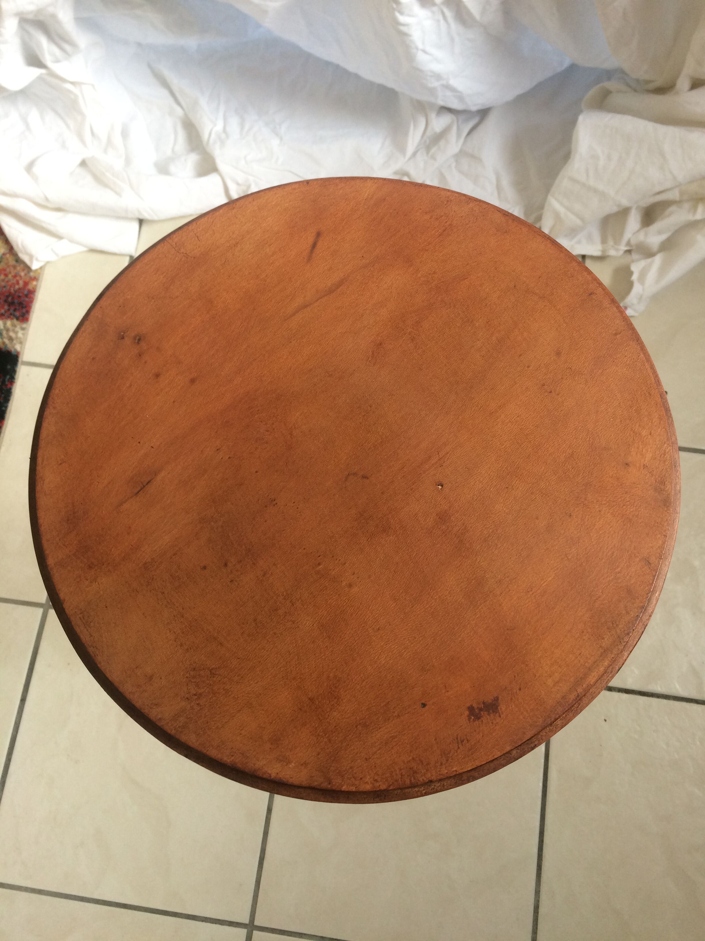 Round end table with tripod mast. 50 years. Medium oak color.