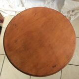 Round end table with tripod mast. 50 years. Medium oak color.