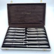 Set of 12 sfam knives in silver metal and stainless steel blades.