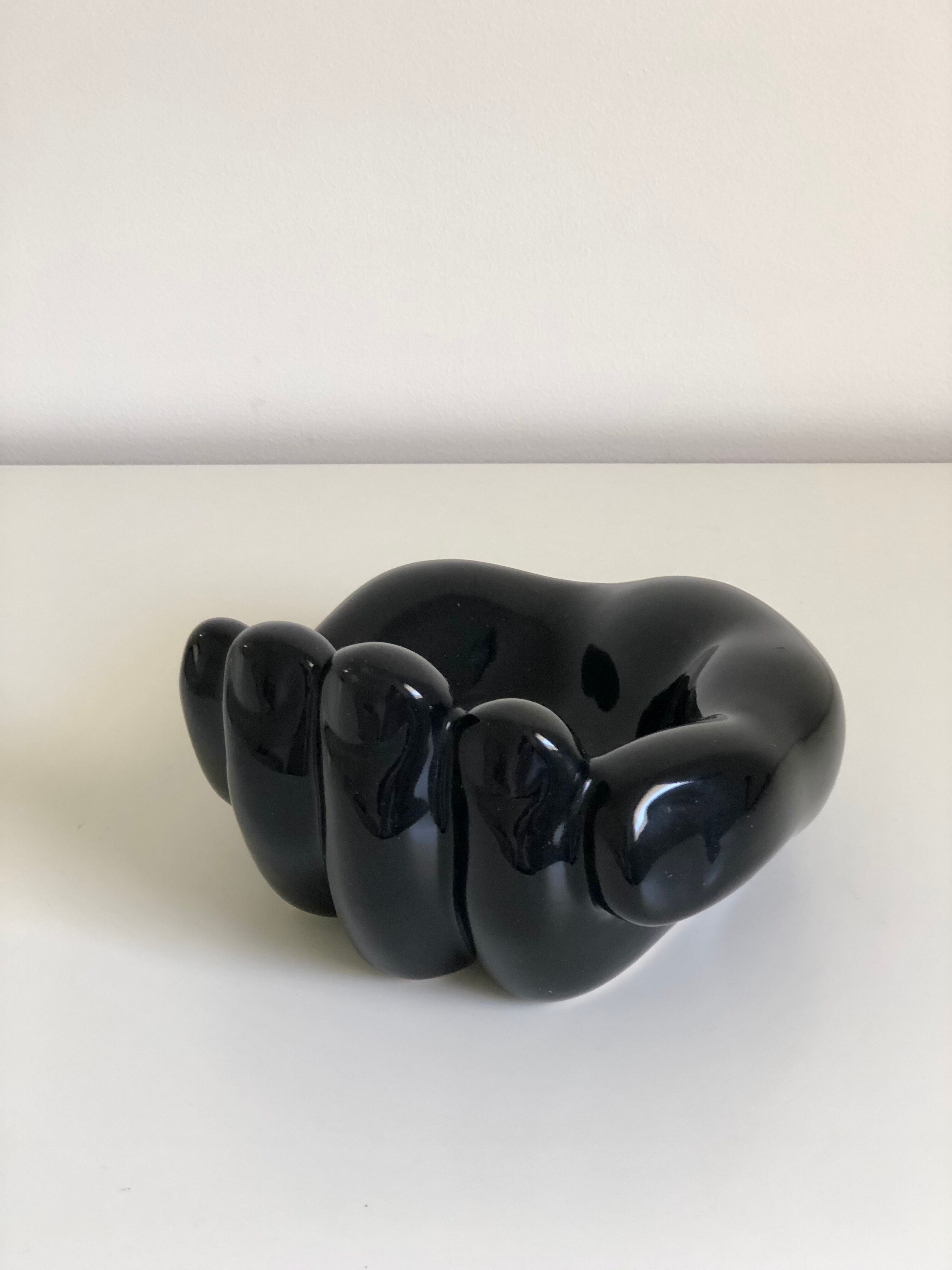 Empty black enamelled hand-shaped ceramic pocket, 1970