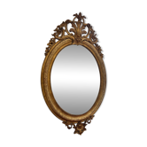 Golden oval mirror
