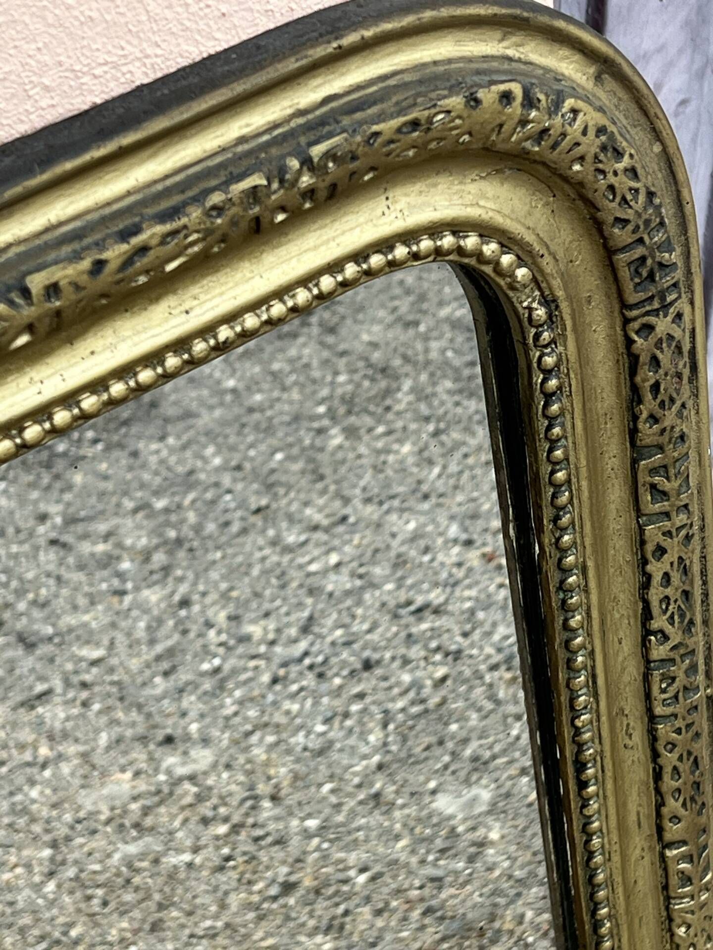 Louis Philippe mirror in gilded wood with an openwork frieze.