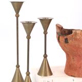 Trio of brass candlesticks by Christian de Beaumont
