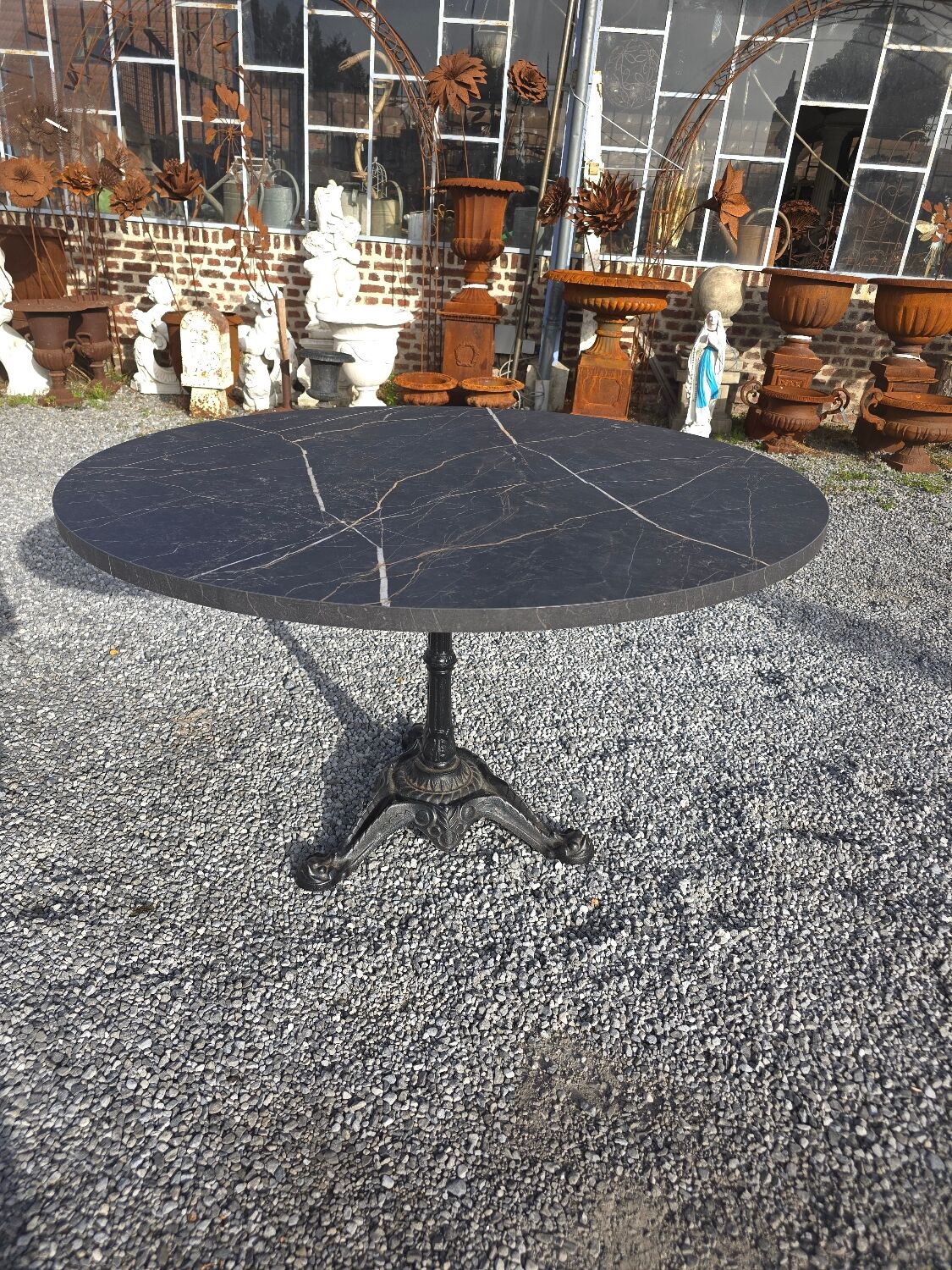 Bistro pedestal table with cast iron base and marble effect top