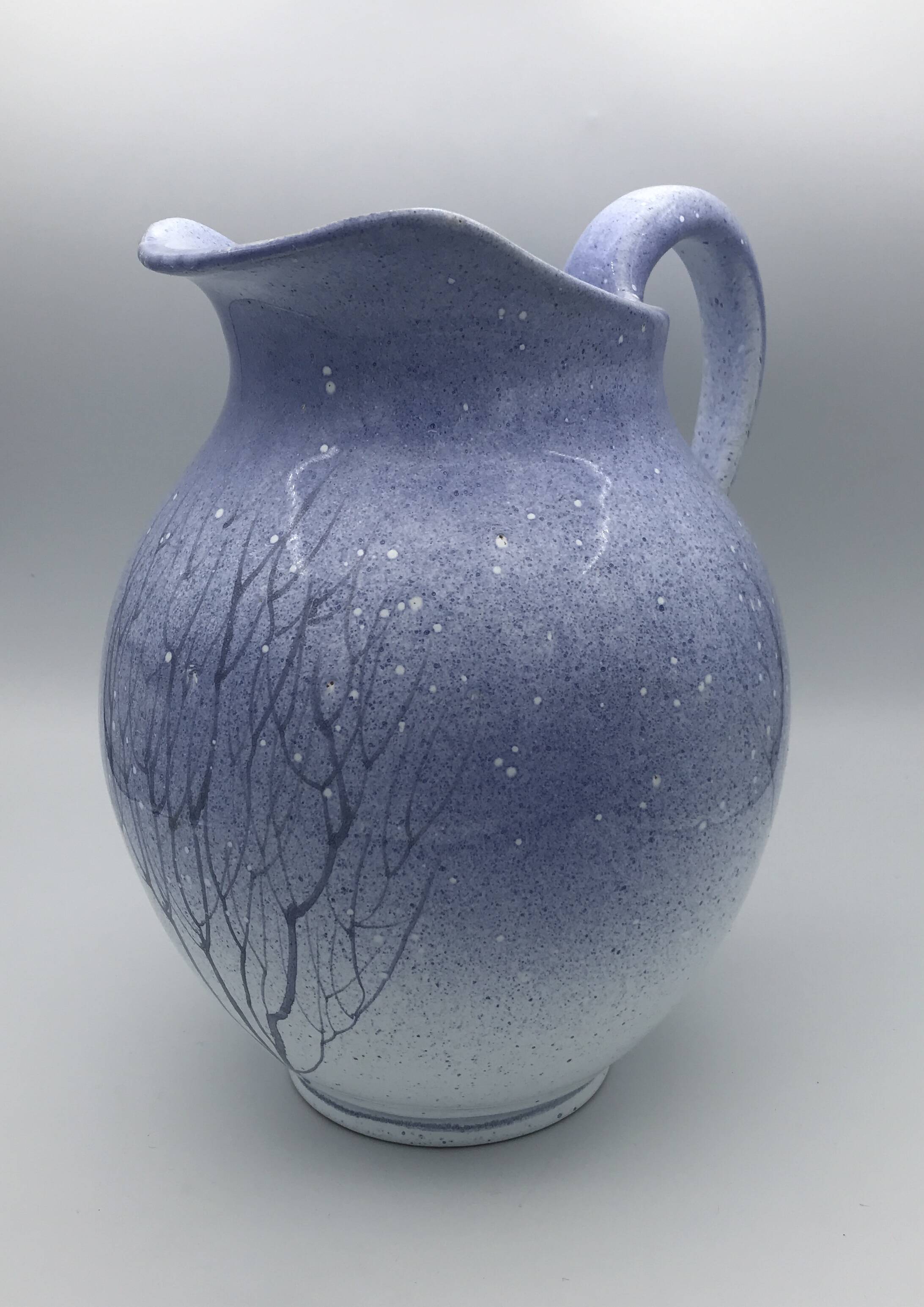 Blue glazed terracotta pitcher with hand-painted decoration, signed