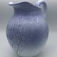 Blue glazed terracotta pitcher with hand-painted decoration, signed