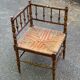 19th-century solid wood corner chair with red and blue rush seating.