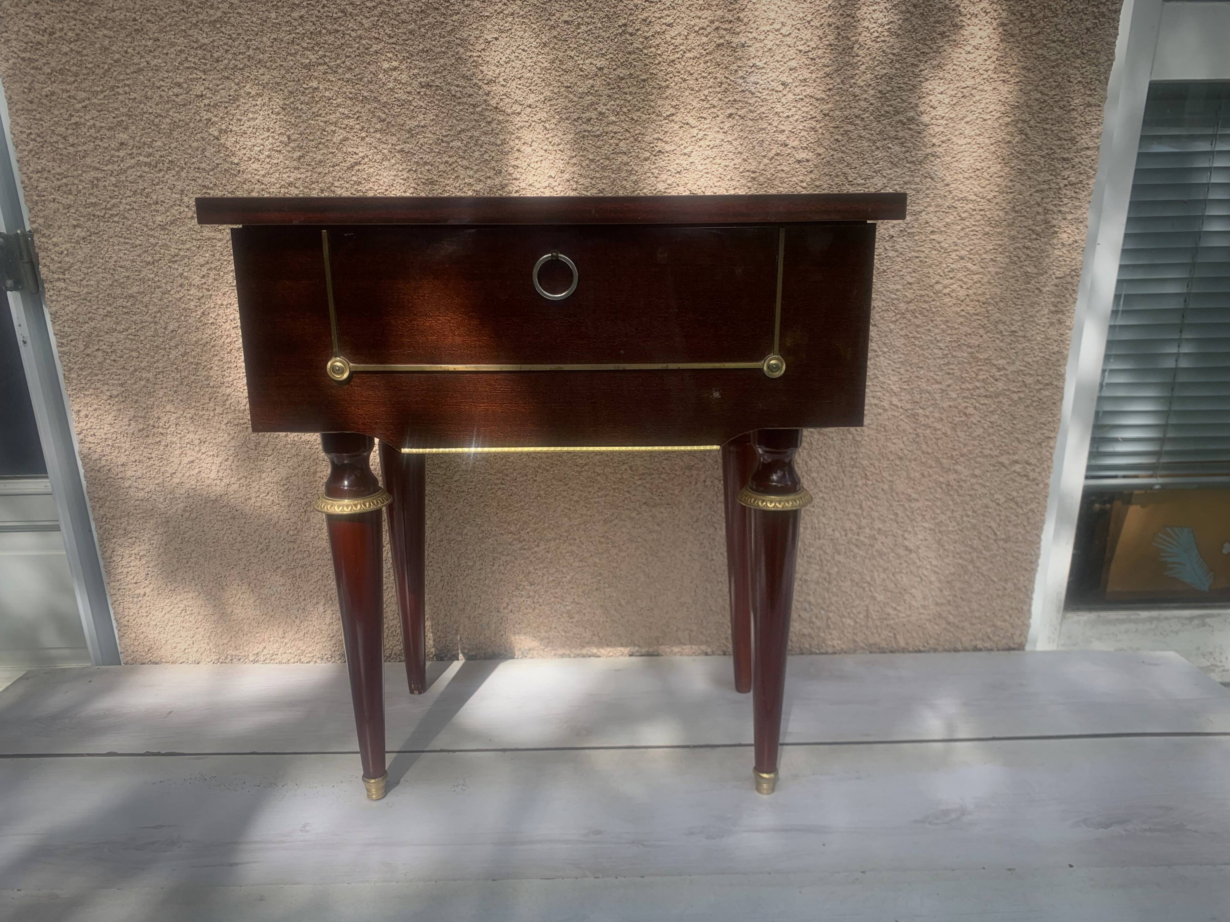 Nightstand with lovely mid-century style gold metal decor.
