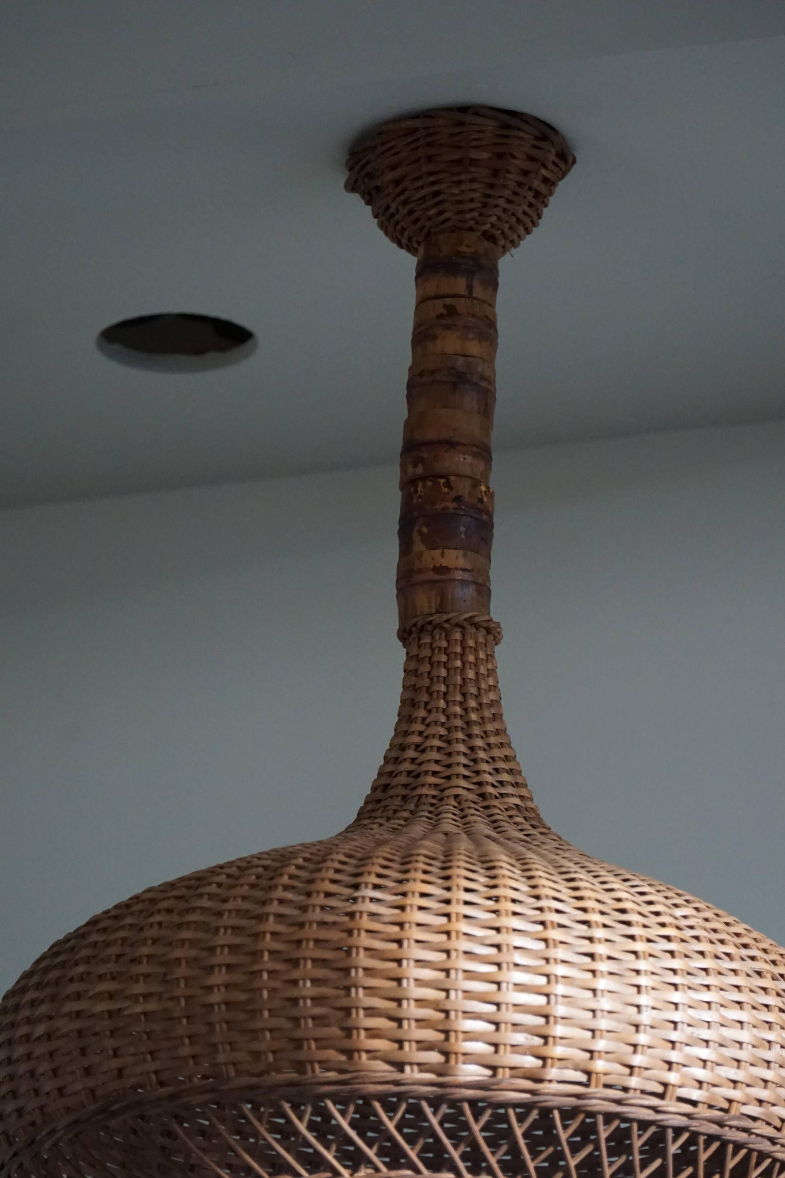 Vintage Danish mid-century rattan pendant light, made in the 1960s.