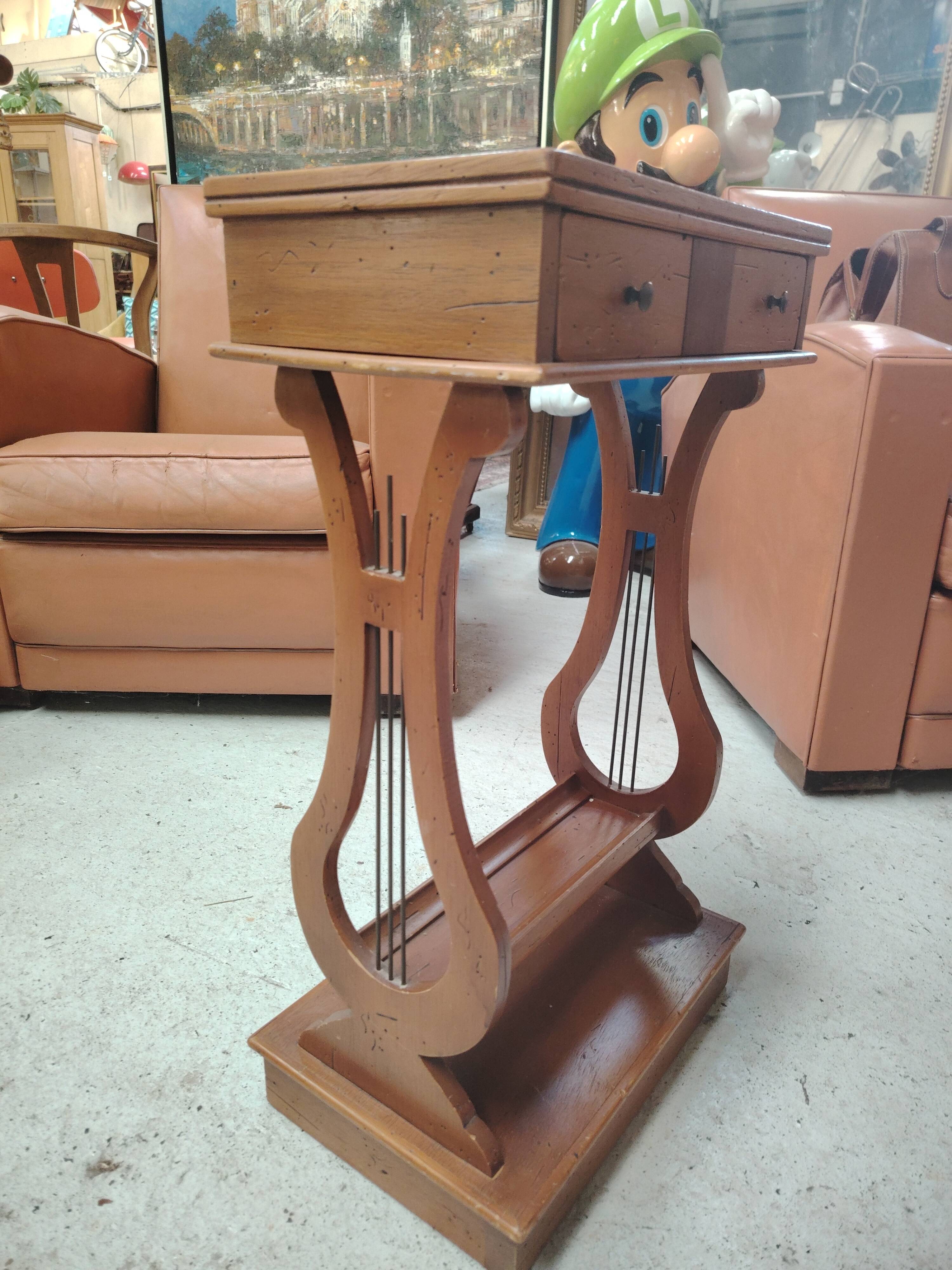 Vintage end table with lyre legs and two drawers.