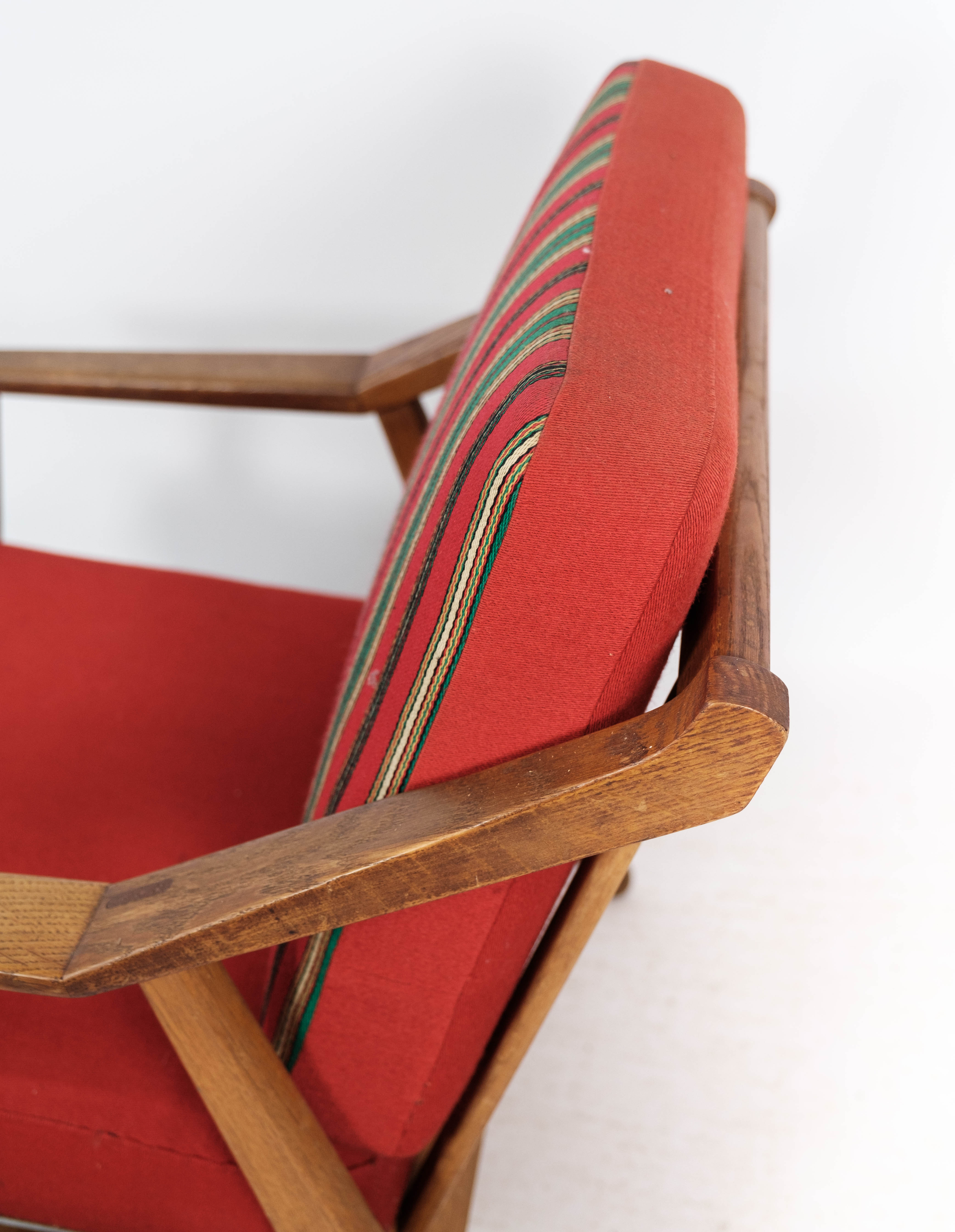 Armchair in oak and upholstered with red fabric, designed by H. Brockmann Pedersen, 1960s