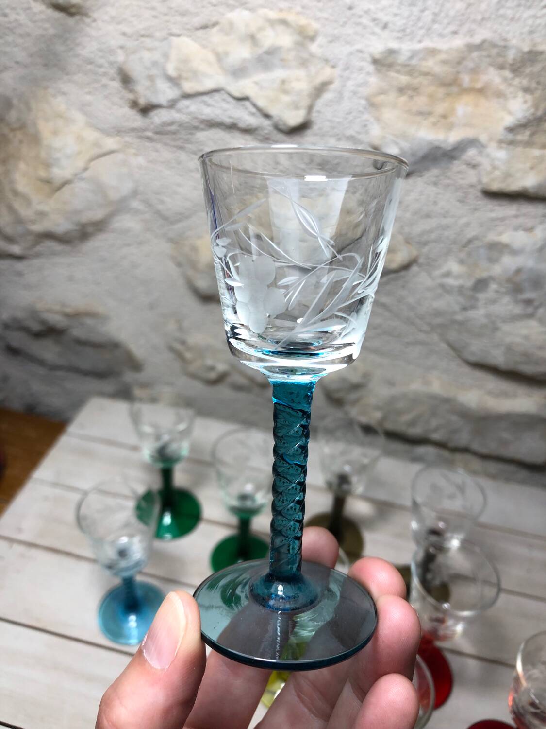 Antique and rare! Sold in a set of 12 colorful twisted stemmed glasses engraved with flowers and leaves
