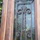 Oak entrance door and its frame and transom, wrought iron gates